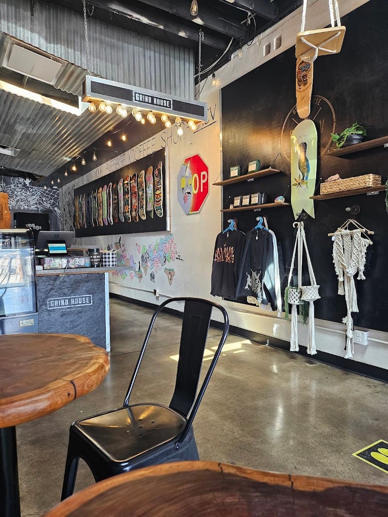 Grind House interior with skateboard decks, local art, plants, and café seating
